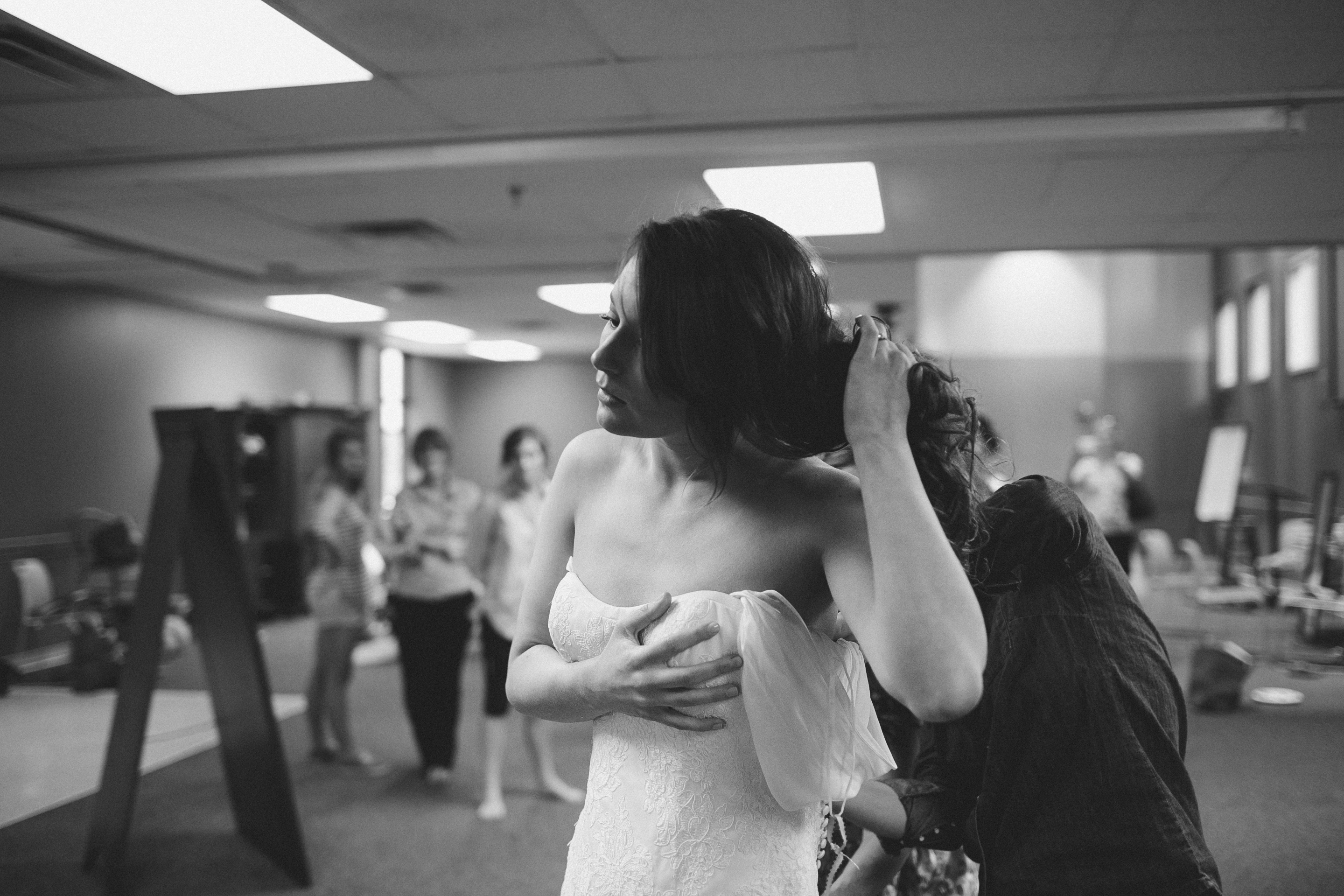 bride-putting-on-dress