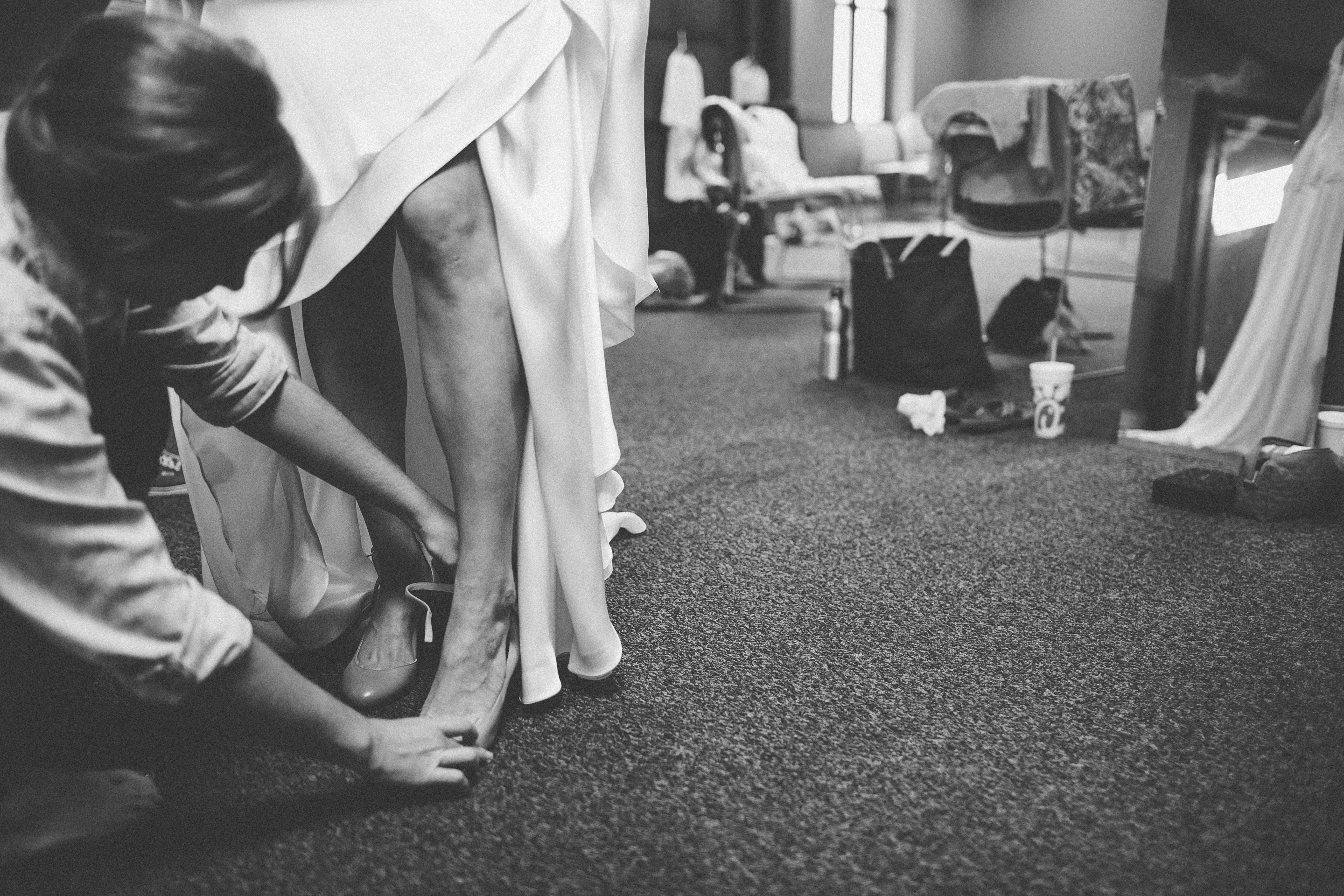 bride-getting-help-with-shoes