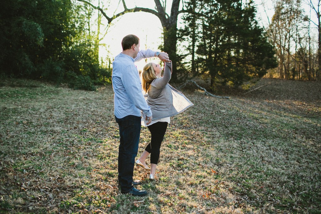 twirl in a field engagement photos slow dancing