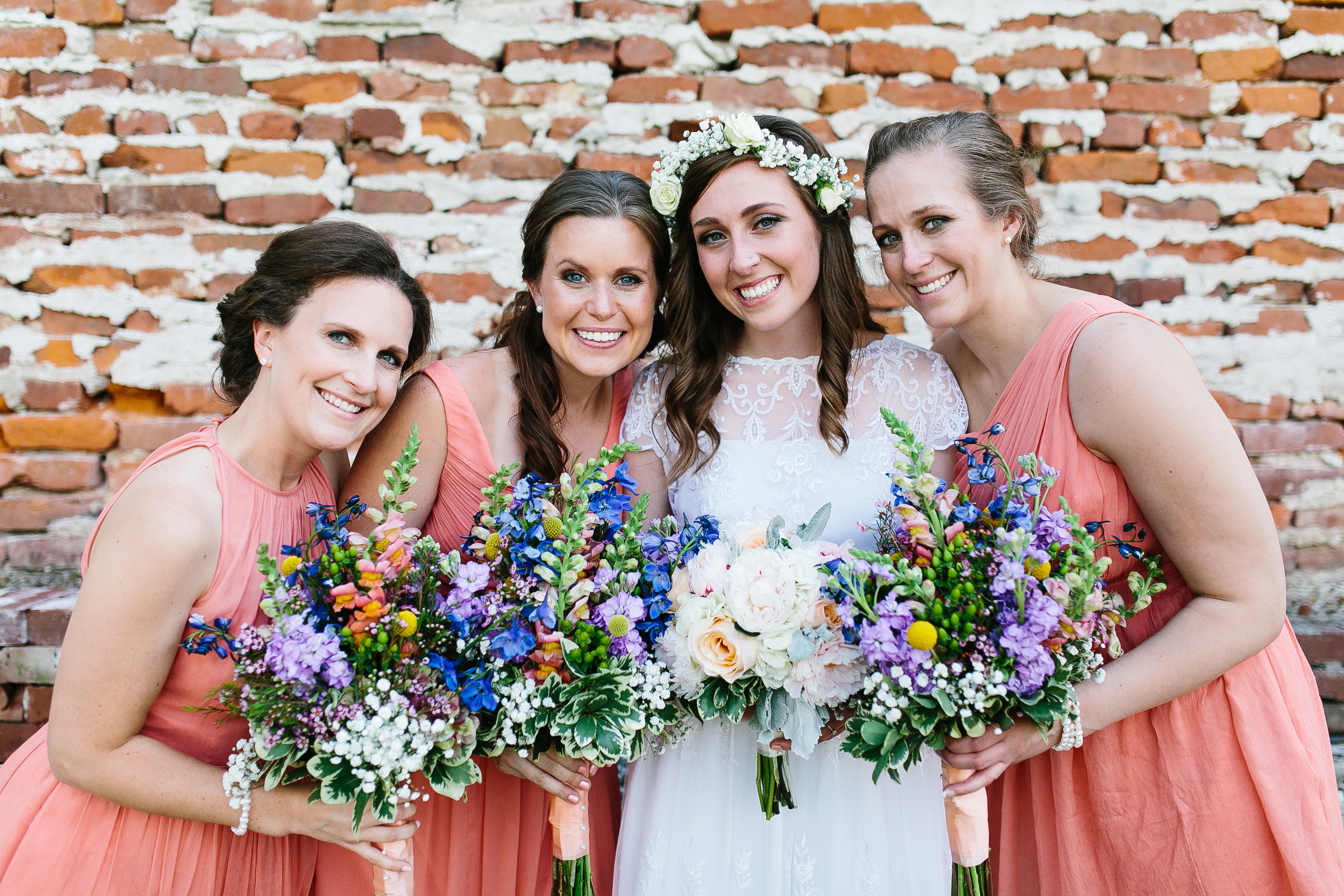 peach bridesmaids dresses. vibrant bouquets. flower crown