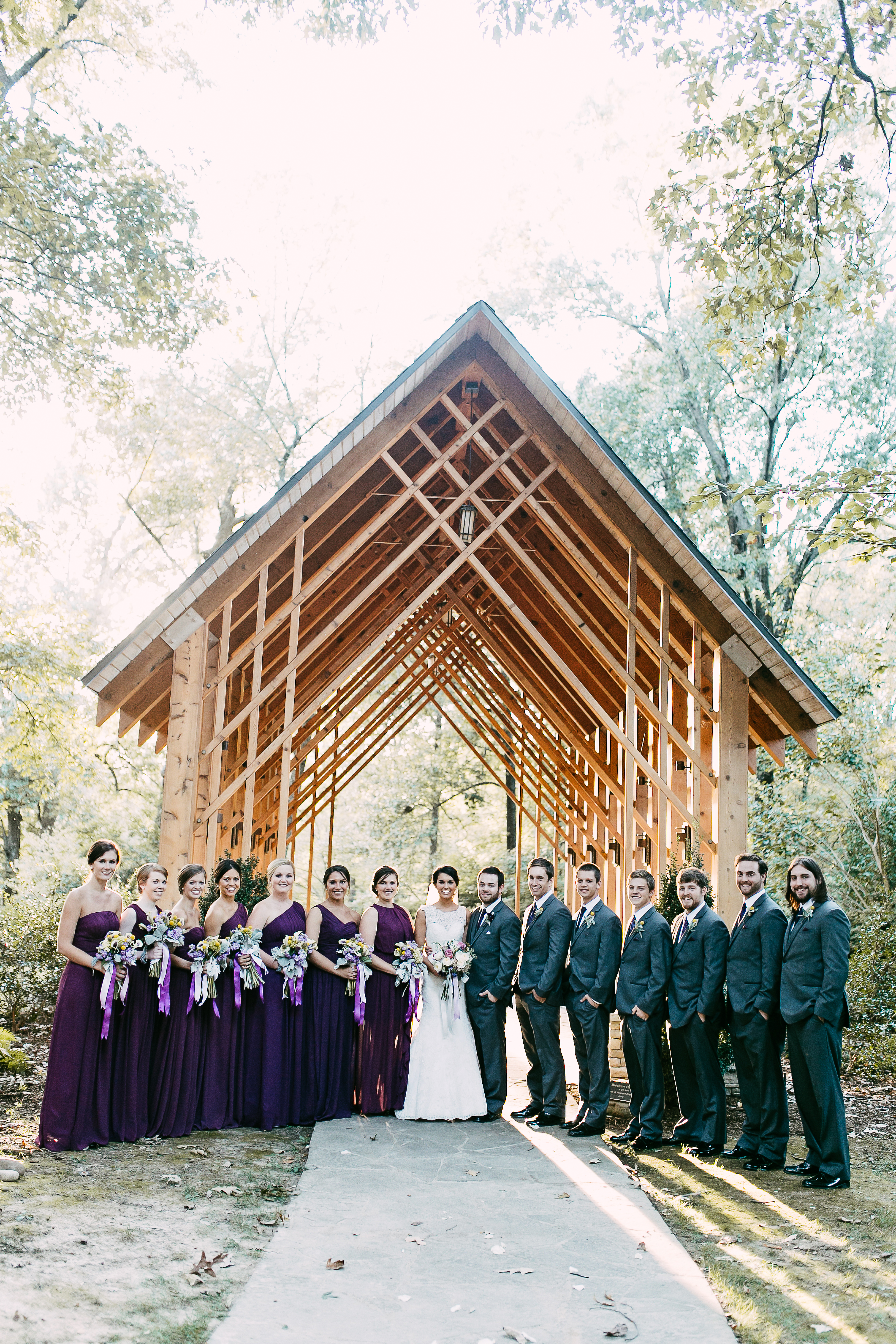deep purple wedding. groom in grey suit.