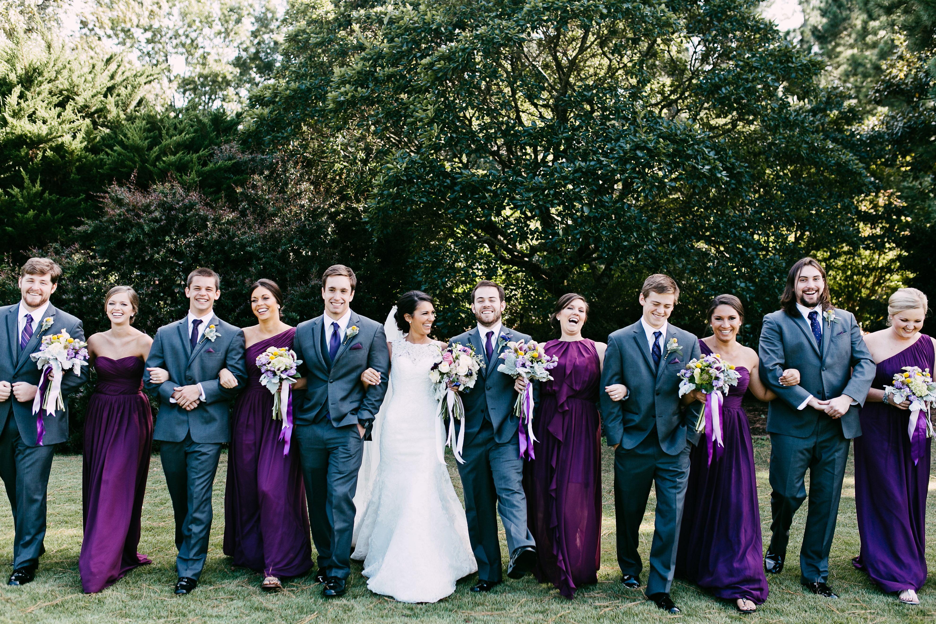 deep purple wedding. groom in grey suit.