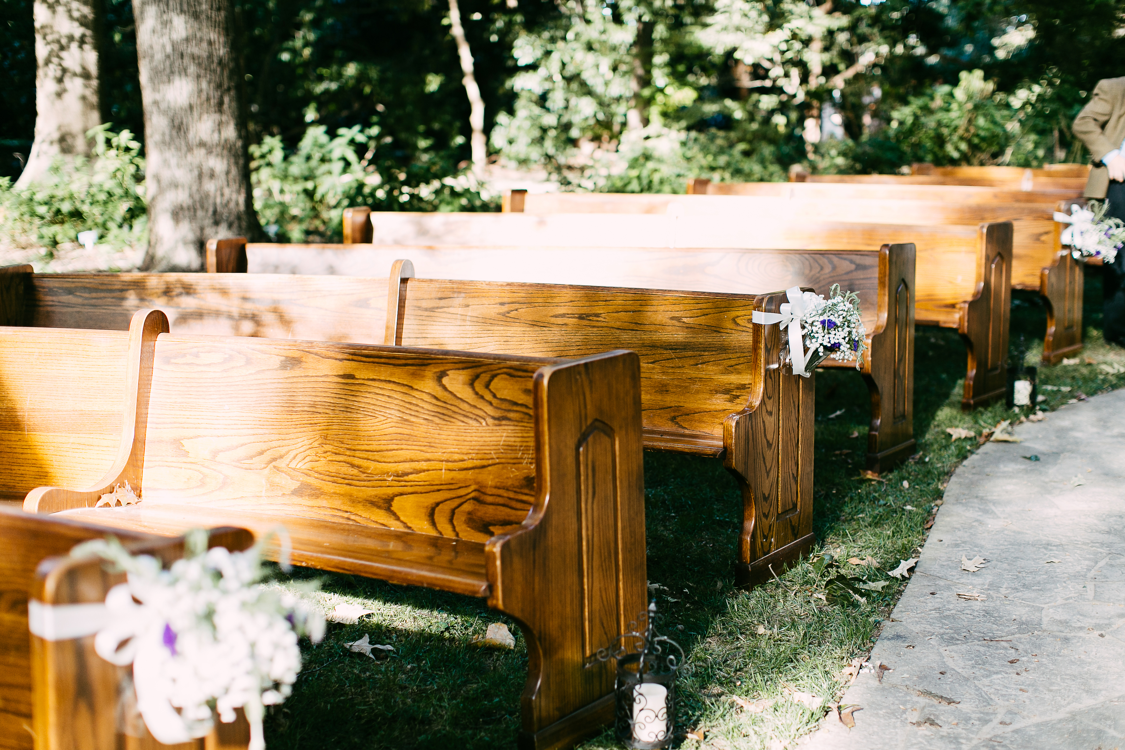church pews at an outdoor wedding